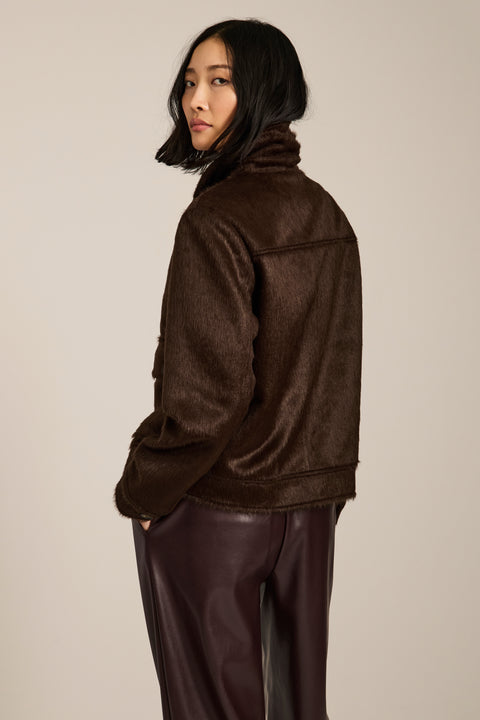 Women's faux calf hair jacket with utility pockets and button-front closure.