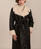 women's black faux shearling belted coat featuring ivory contrast trim, oversized notched collar, zip-front closure and zip pockets.