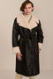 women's black faux shearling belted coat featuring ivory contrast trim, oversized notched collar, zip-front closure and zip pockets.