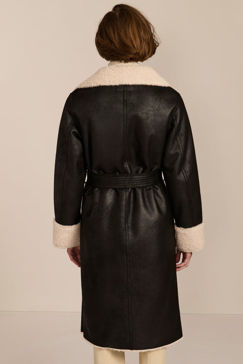 women's black faux shearling belted coat featuring ivory contrast trim, oversized notched collar, zip-front closure and zip pockets.