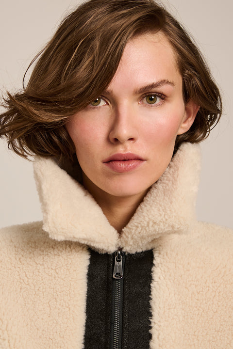 Women's faux shearling and faux leather jacket with zip front and oversized collar in ivory and black