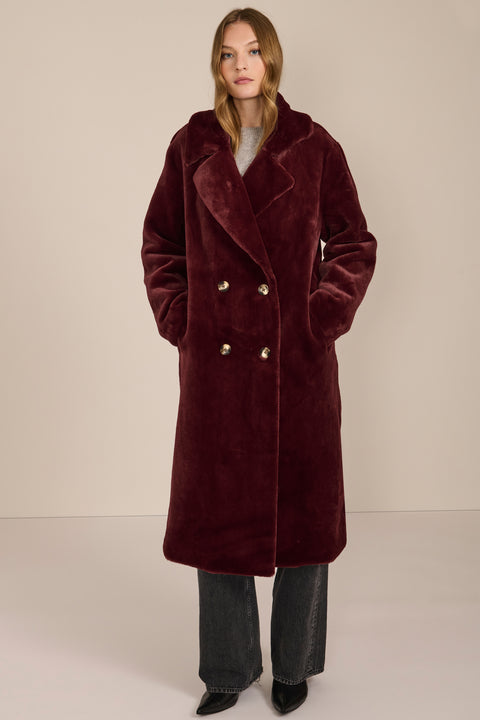 women's Plush Faux Fur Coat, featuring a long double-breasted silhouette and oversized notched lapels.