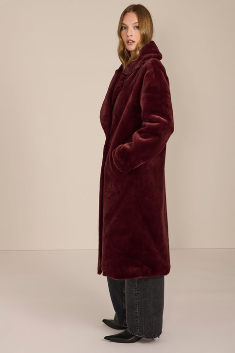 women's Plush Faux Fur Coat, featuring a long double-breasted silhouette and oversized notched lapels.