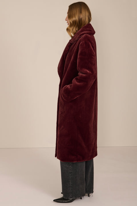 women's Plush Faux Fur Coat, featuring a long double-breasted silhouette and oversized notched lapels.