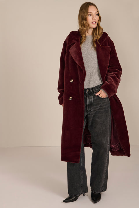 women's Plush Faux Fur Coat, featuring a long double-breasted silhouette and oversized notched lapels.