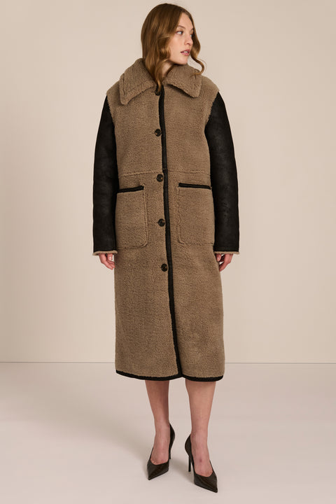 women's Mixed Media Faux Shearling Coat in taupe with black faux leather contrast sleeves, oversized collar and longline silhouette.