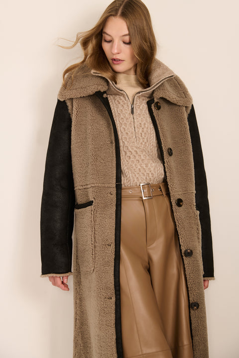 women's Mixed Media Faux Shearling Coat in taupe with black faux leather contrast sleeves, oversized collar and longline silhouette.
