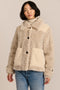 women's cream mixed-media teddy jacket with contrasting faux shearling textures, oversized patch pockets, button-front closure, and a plush stand collar.