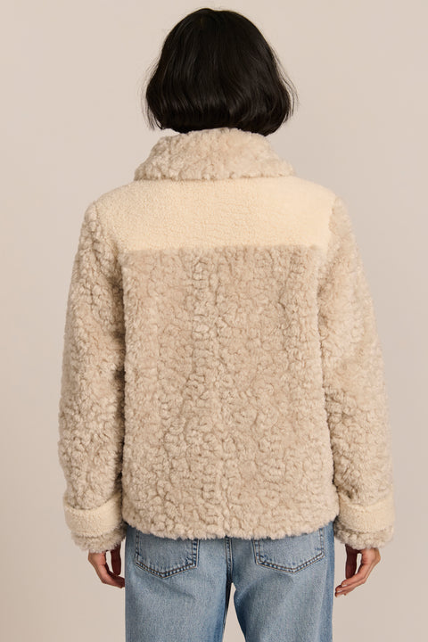 women's cream mixed-media teddy jacket with contrasting faux shearling textures, oversized patch pockets, button-front closure, and a plush stand collar.