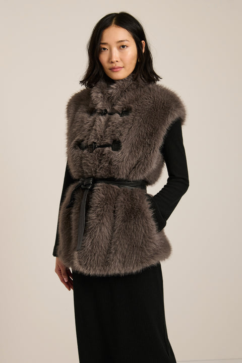 Women's faux fur vest with toggle closures, stand collar, and side pockets.