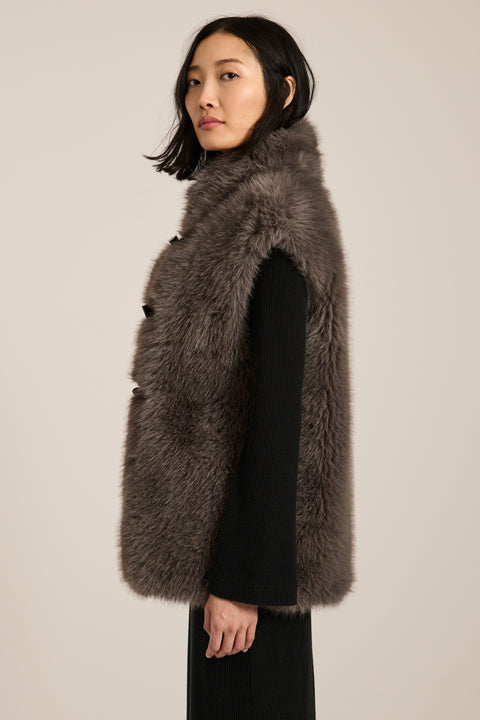 Women's faux fur vest with toggle closures, stand collar, and side pockets.