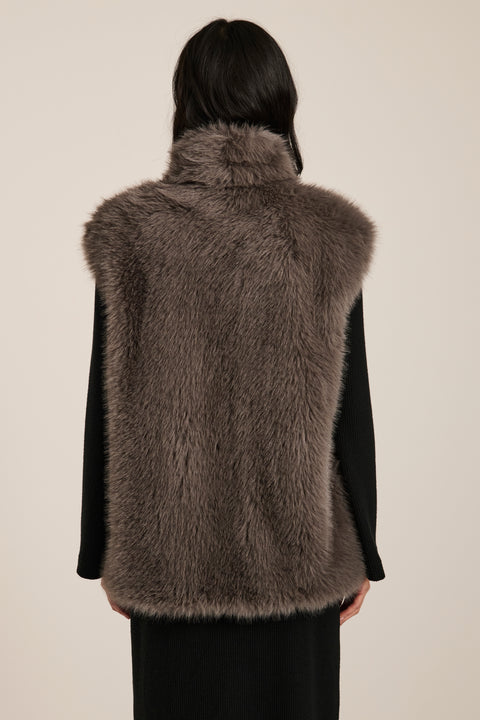 Women's faux fur vest with toggle closures, stand collar, and side pockets.