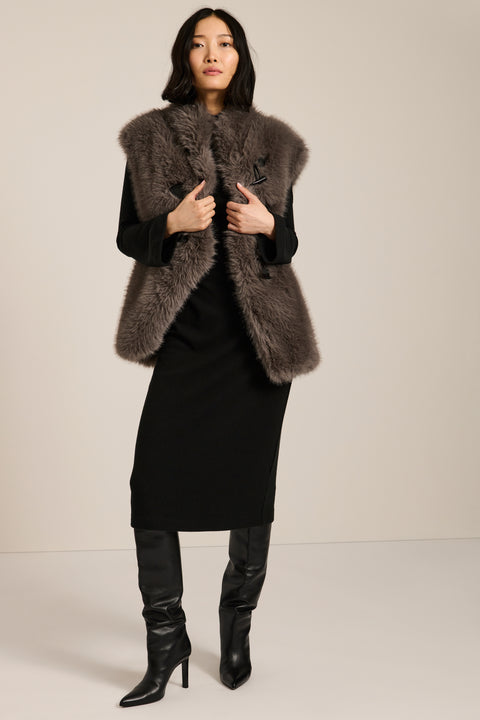 Women's faux fur vest with toggle closures, stand collar, and side pockets.