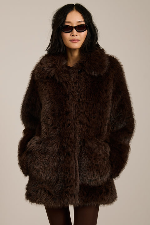 Spotted faux fur coat with oversized notch collar, button-front closure and patch pockets with side entry.