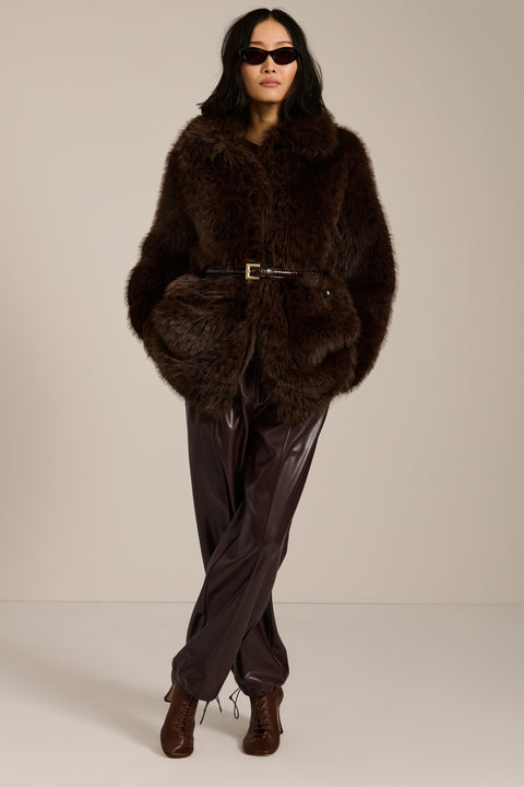 Spotted faux fur coat with oversized notch collar, button-front closure and patch pockets with side entry.