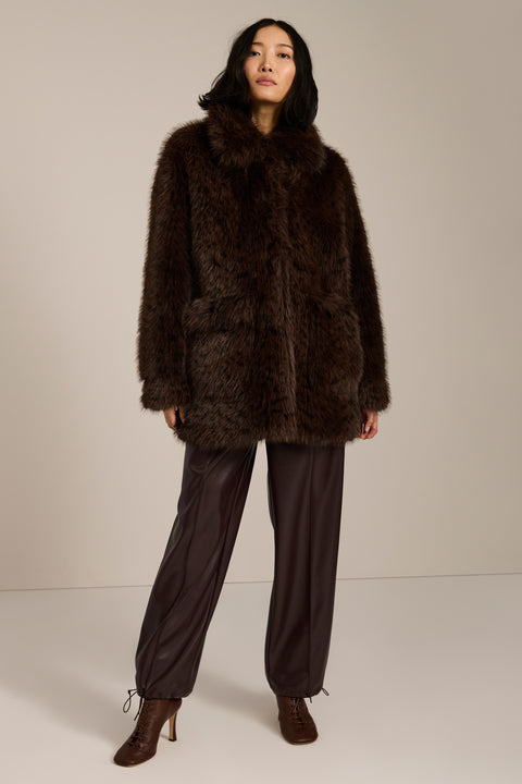 Spotted faux fur coat with oversized notch collar, button-front closure and patch pockets with side entry.