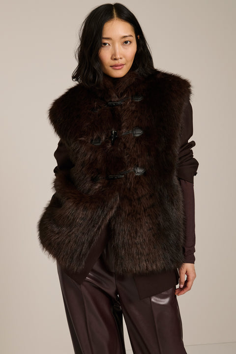 Women's faux fur vest with toggle closures, stand collar, and side pockets.