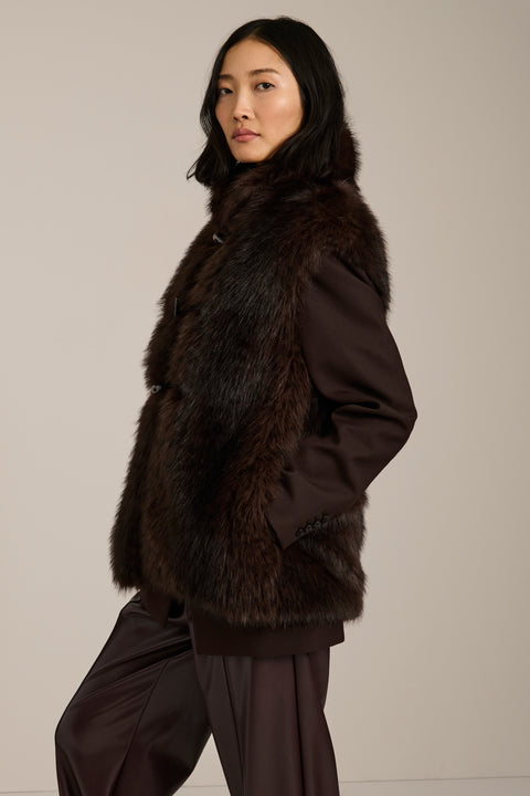 Women's faux fur vest with toggle closures, stand collar, and side pockets.