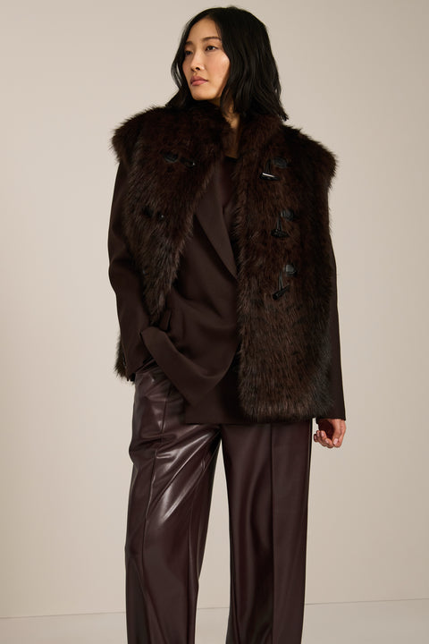Women's faux fur vest with toggle closures, stand collar, and side pockets.