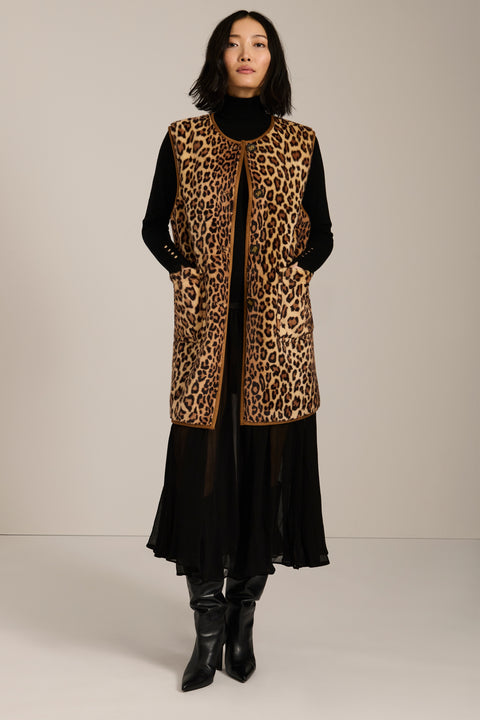 Long leopard print faux fur vest with collarless silhouette, faux leather trim and streamlined fit.