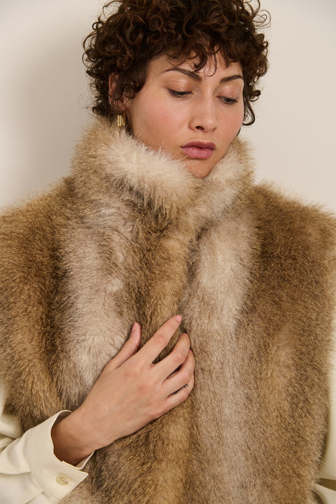 Plush faux fur vest with oversized stand collar, hidden front closure and side seam pockets.