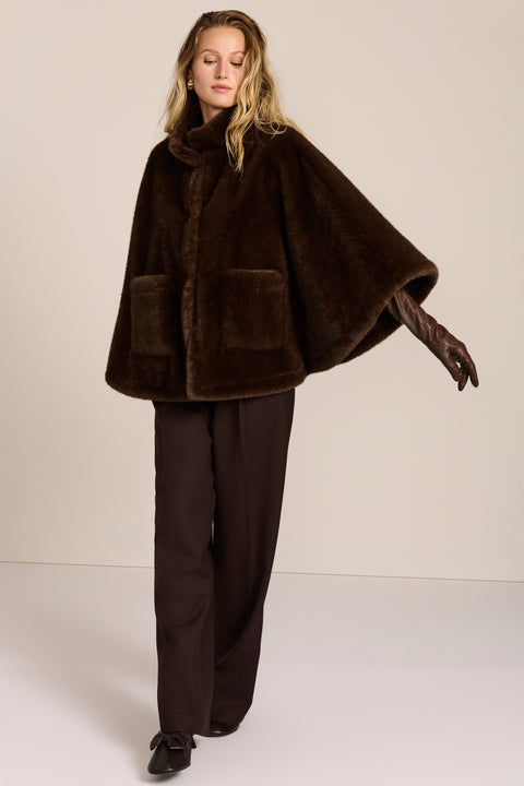 women's Faux Fur Cape Jacket in chocolate brown with a stand collar, sweeping cape sleeves and oversized patch pockets.