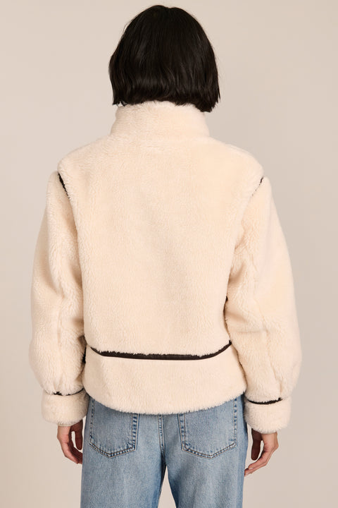 women's ivory sherpa jacket featuring a stand collar, contrast trim, zip-front closure and adjustable buckle tabs at the sides.