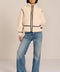women's ivory sherpa jacket featuring a stand collar, contrast trim, zip-front closure and adjustable buckle tabs at the sides.