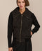 Women's quilted bomber jacket with knit sleeves.