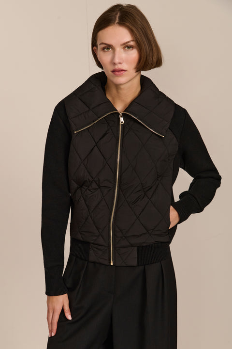 Women's quilted bomber jacket with knit sleeves.