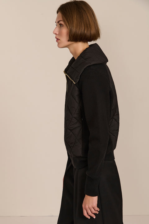 Women's quilted bomber jacket with knit sleeves.