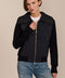 Women's quilted bomber jacket with knit sleeves.