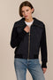 Women's quilted bomber jacket with knit sleeves.
