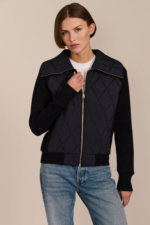 Women's quilted bomber jacket with knit sleeves.