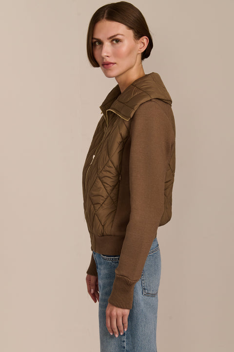 Women's quilted bomber jacket with knit sleeves.