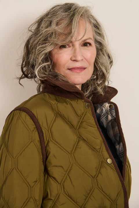 Women's quilted jacket with corduroy collar, snap-front closure, and patch pockets in olive green