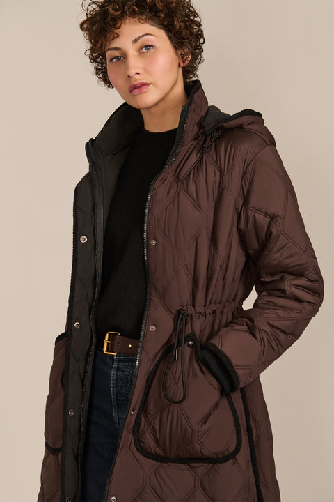 women's Long Quilted Puffer Coat with drawstring waist, hood, diamond quilting and longline silhouette.
