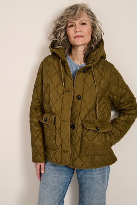 Women's diamond quilted hooded jacket with drawcord waist and oversized patch pockets.
