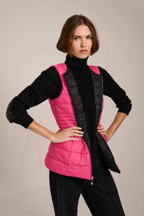 women's reversible black and pink puffer vest.