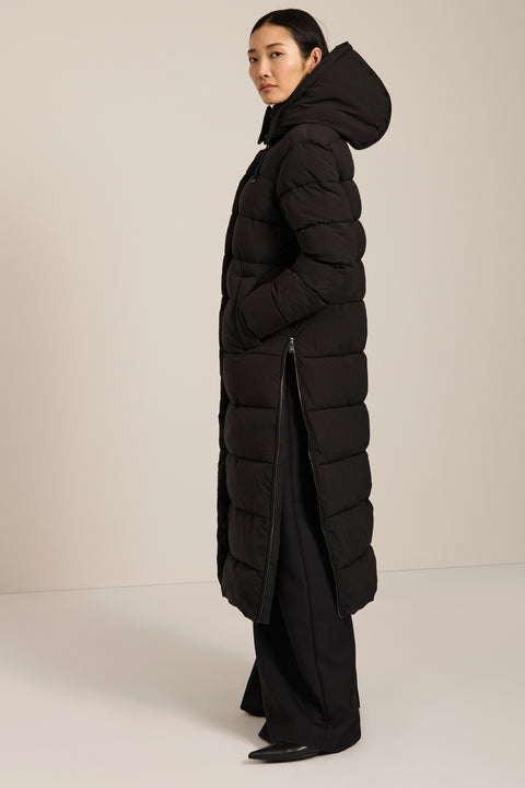 Long insulated puffer coat with removable hood, hidden placket, side zip vents and zippered pockets.