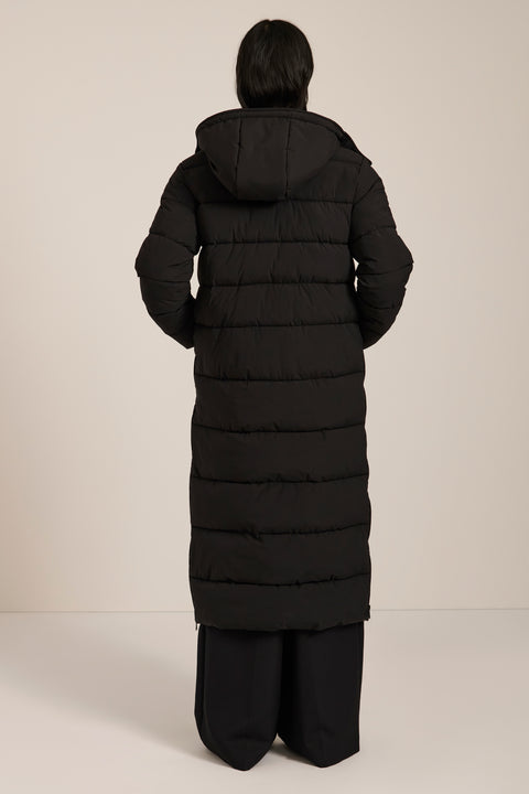 Long insulated puffer coat with removable hood, hidden placket, side zip vents and zippered pockets.