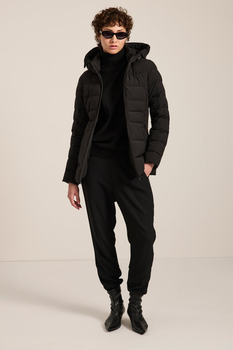 Packable hooded puffer jacket with drawstring hood, recycled insulation, zip pockets and fitted silhouette.