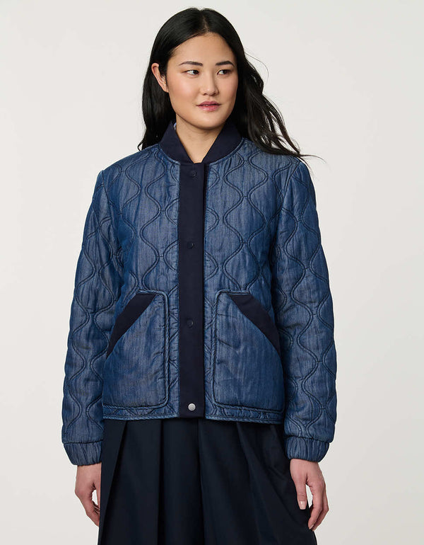 Women’s quilted denim bomber jacket with front patch pockets and contrast ribbed trim.