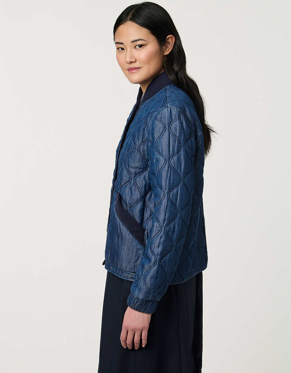 Women’s quilted denim bomber jacket with front patch pockets and contrast ribbed trim.