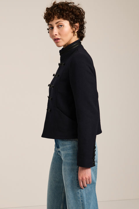 Military-inspired jacket with stand collar, tonal hook closures, angled welt pockets and tailored silhouette.