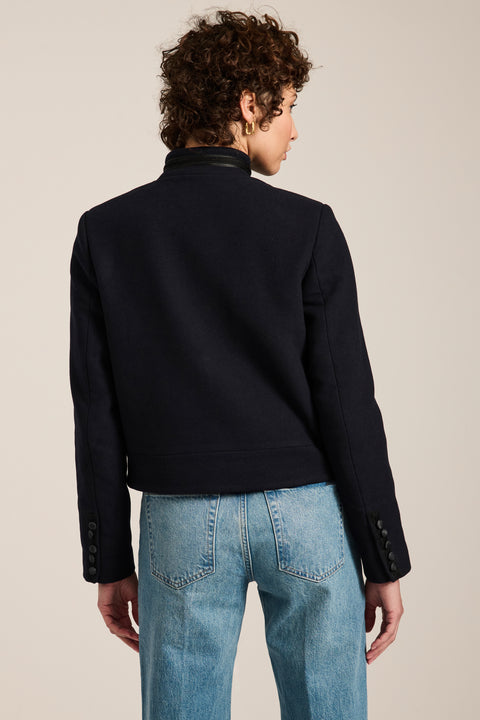 Military-inspired jacket with stand collar, tonal hook closures, angled welt pockets and tailored silhouette.