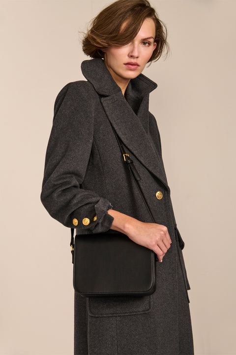 classic  wool coat with calf length cut and patch pockets ideal for adding sophistication to everyday outfits