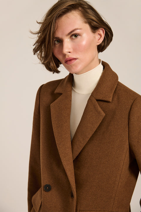 Women's double-breasted blazer coat with tailored lapels and mid-thigh silhouette.
