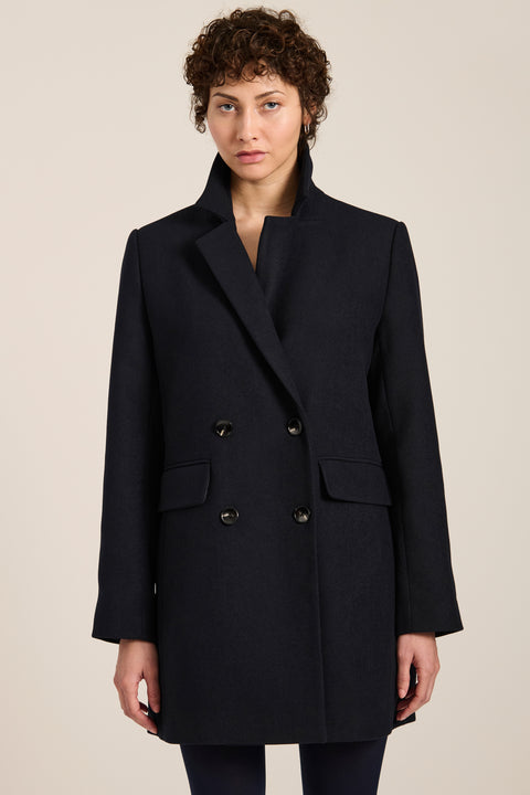 Women's double-breasted blazer coat with tailored lapels and mid-thigh silhouette.