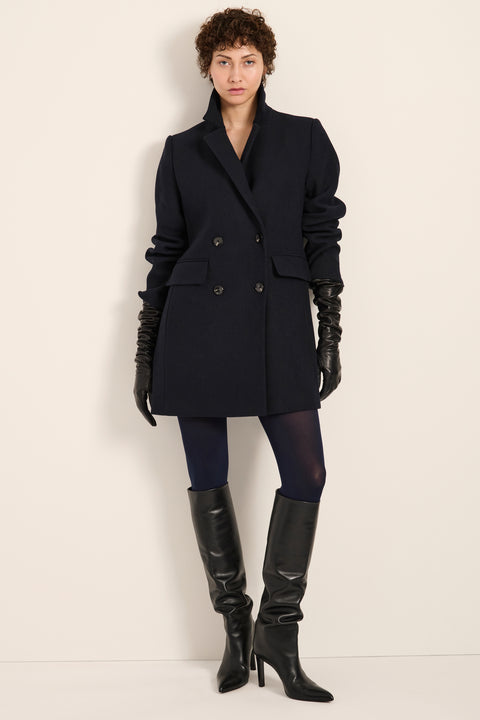 Women's double-breasted blazer coat with tailored lapels and mid-thigh silhouette.